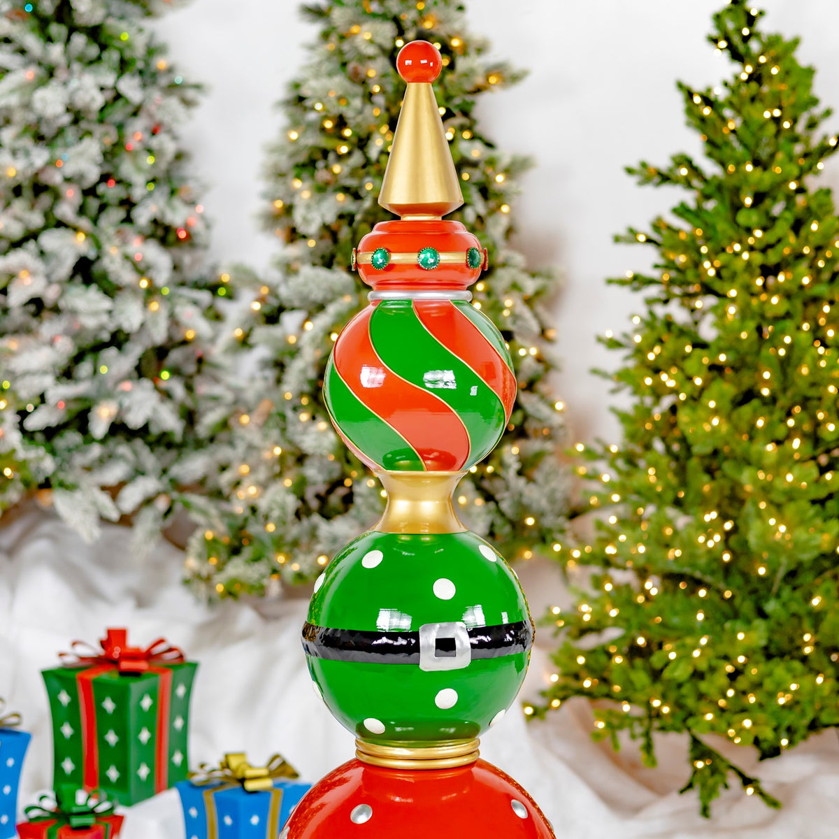 Closer view of the tower’s striped upper ornament and green sphere with white dots and a black belt.