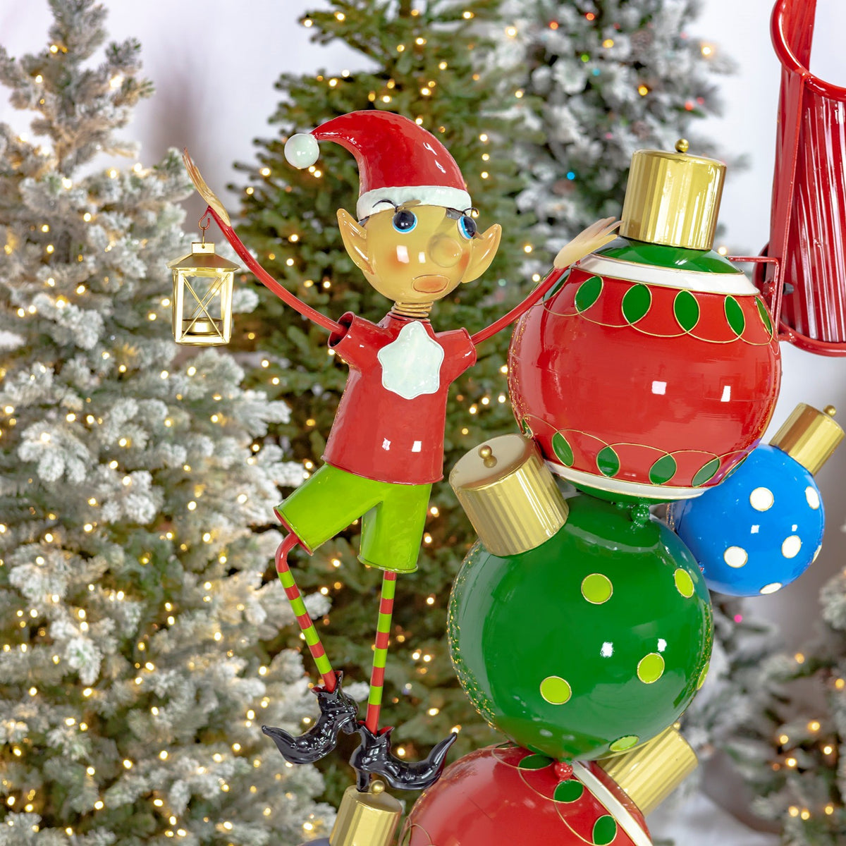 Red-and-green elf holding a gold lantern beside the archway ornament pillar