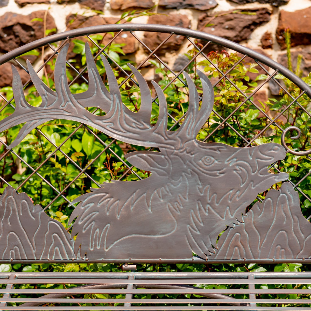 Close-up of the embossed caribou head and antlers on the iron bench back