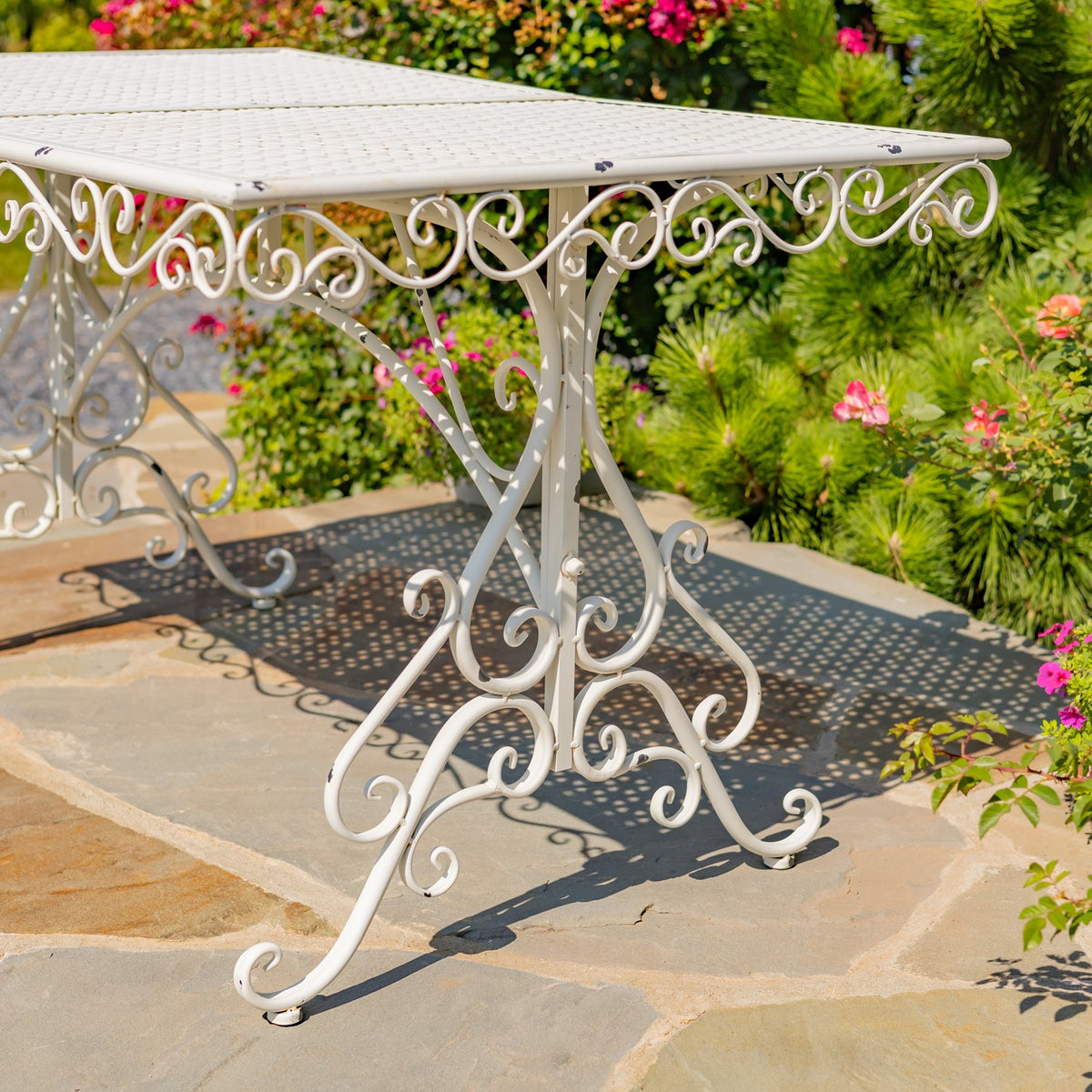 Close view of the table's perforated top, curled apron, and decorative curved legs.
