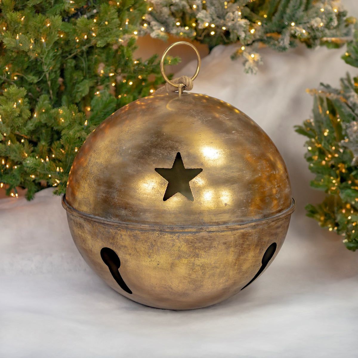 Single rounded gold bell with a hanging ring and a star cutout on its front.