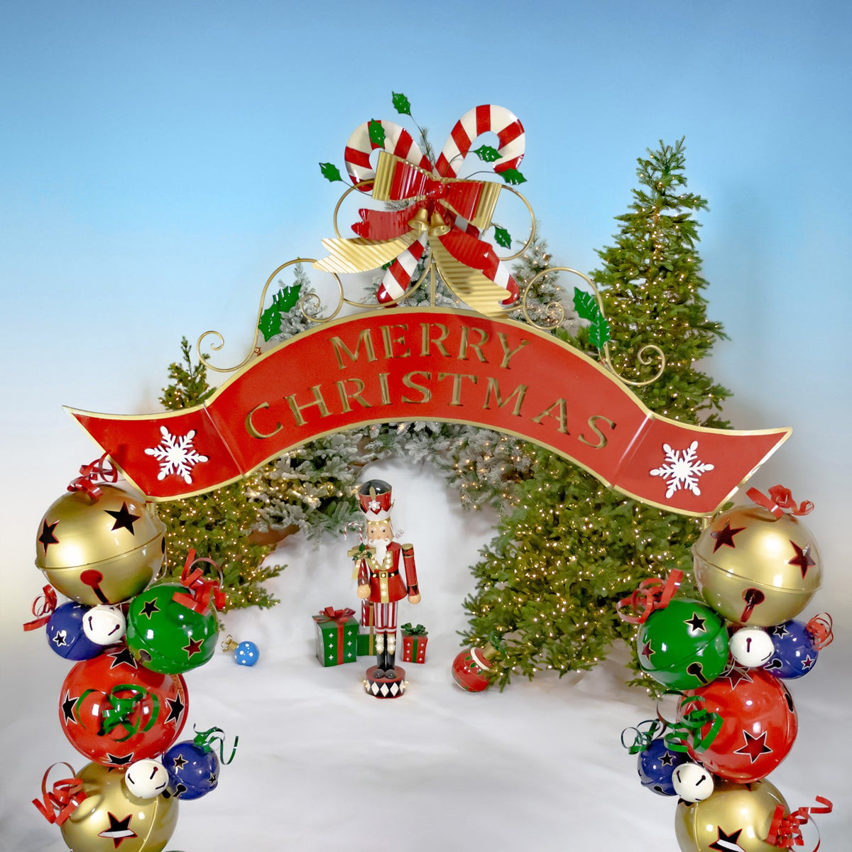 Christmas archway with red Merry Christmas banner and bell pillars