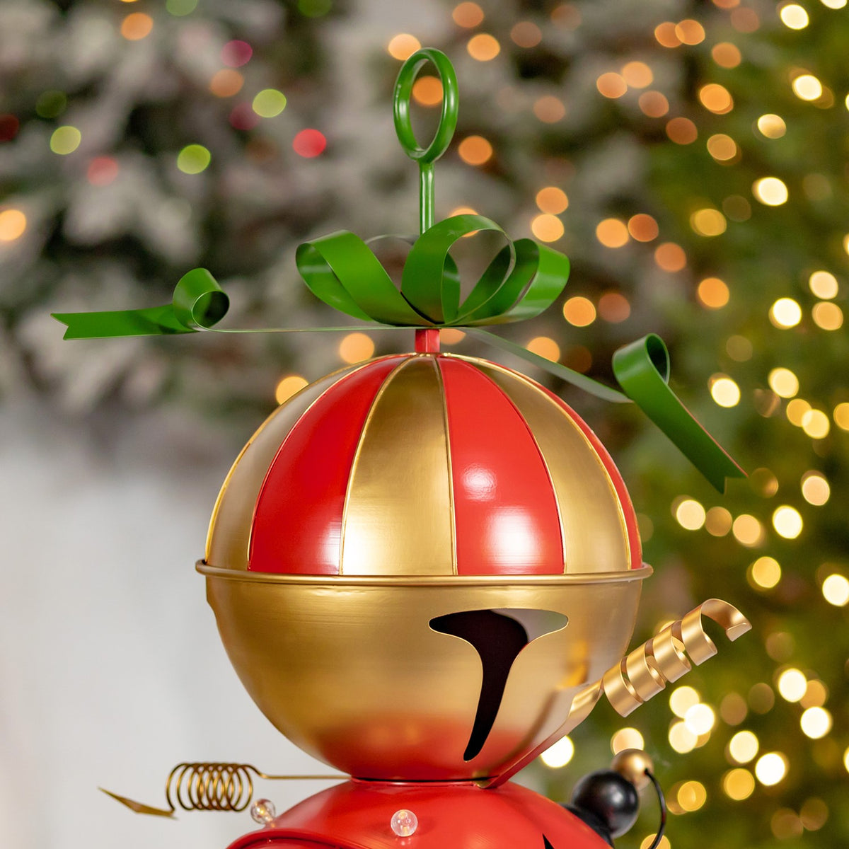 The sleigh’s gold-and-red bell-shaped top with a green bow and curled gold decoration.