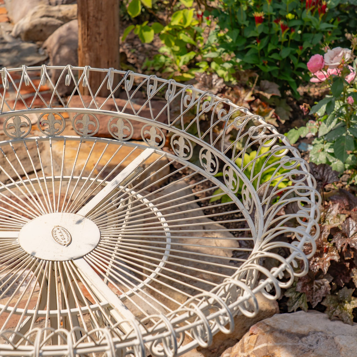 Close-up of the round wire basket with radiating base spokes and decorative circular motifs.