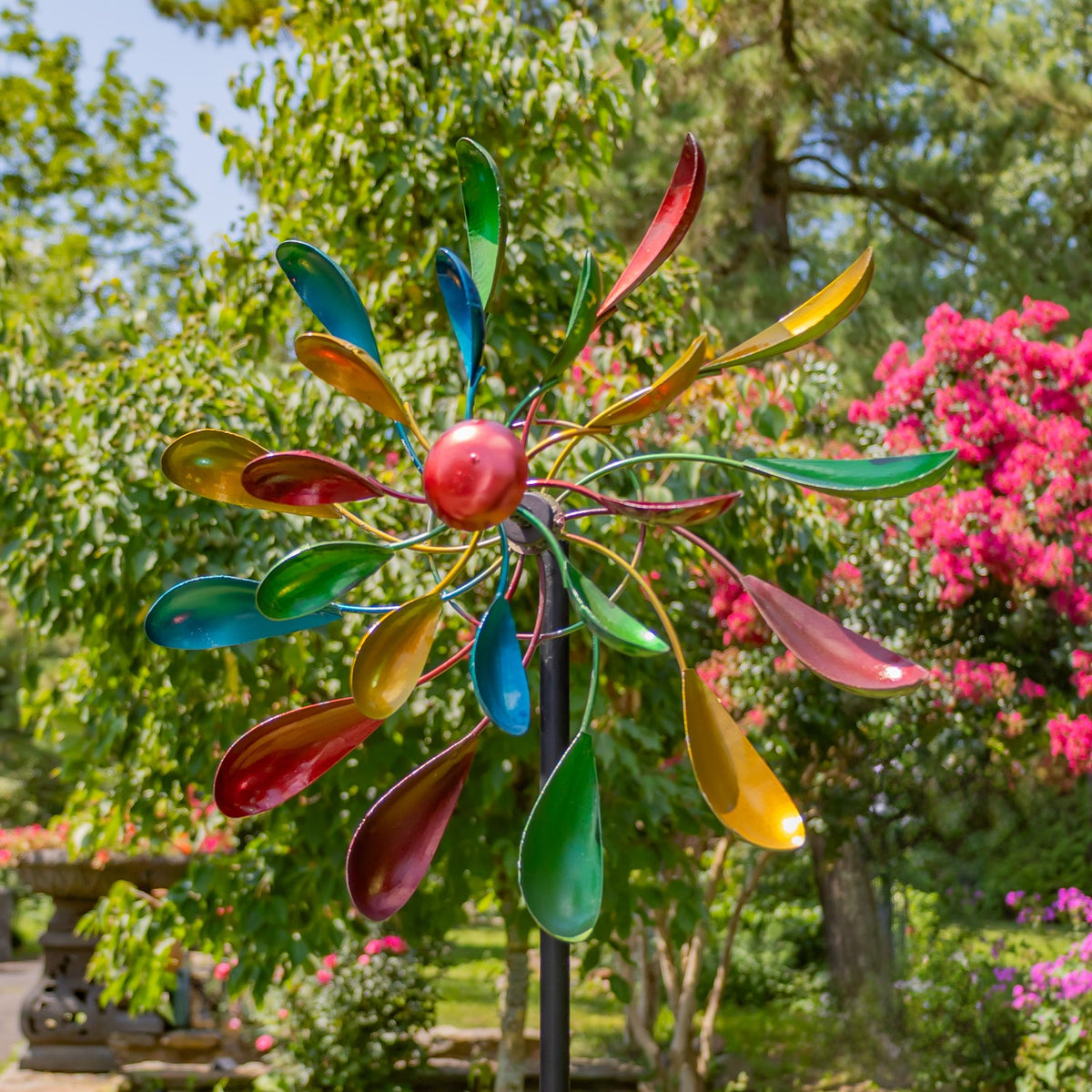 Colorful windmill stake viewed from the front in a garden