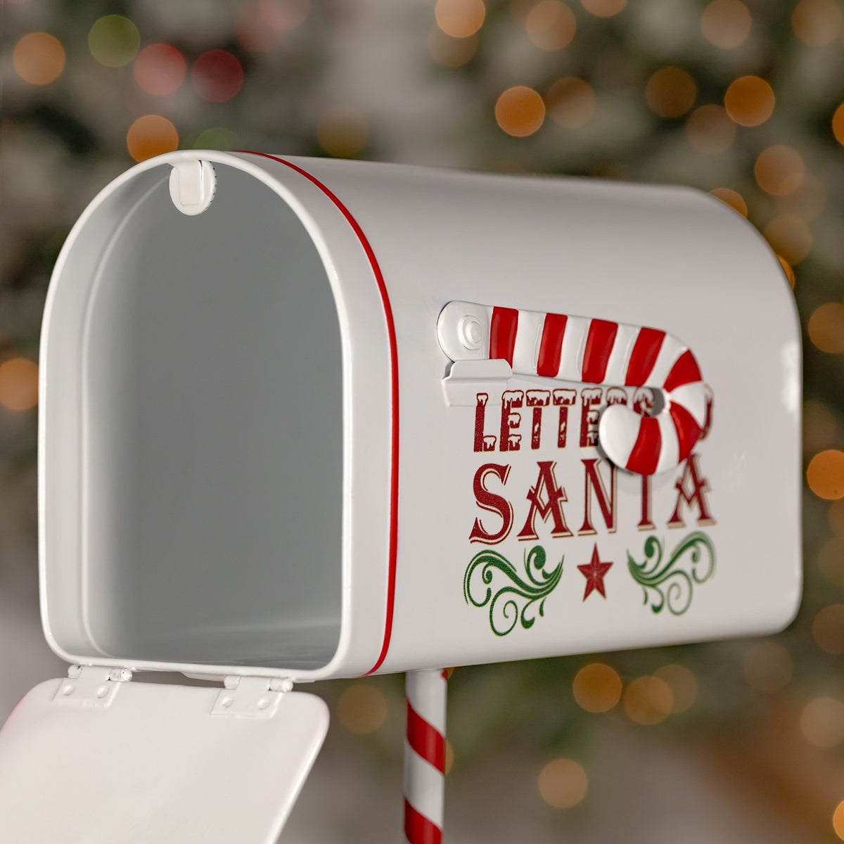 White mailbox with its door open, showing the empty interior and candy cane decoration on the side.