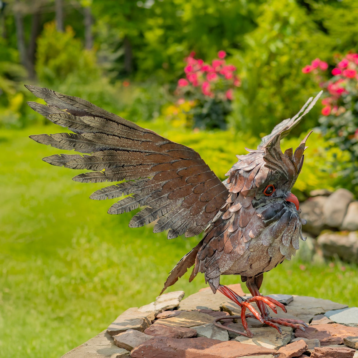 Side view of the owl sculpture showing its feathered body and broad outstretched wing.