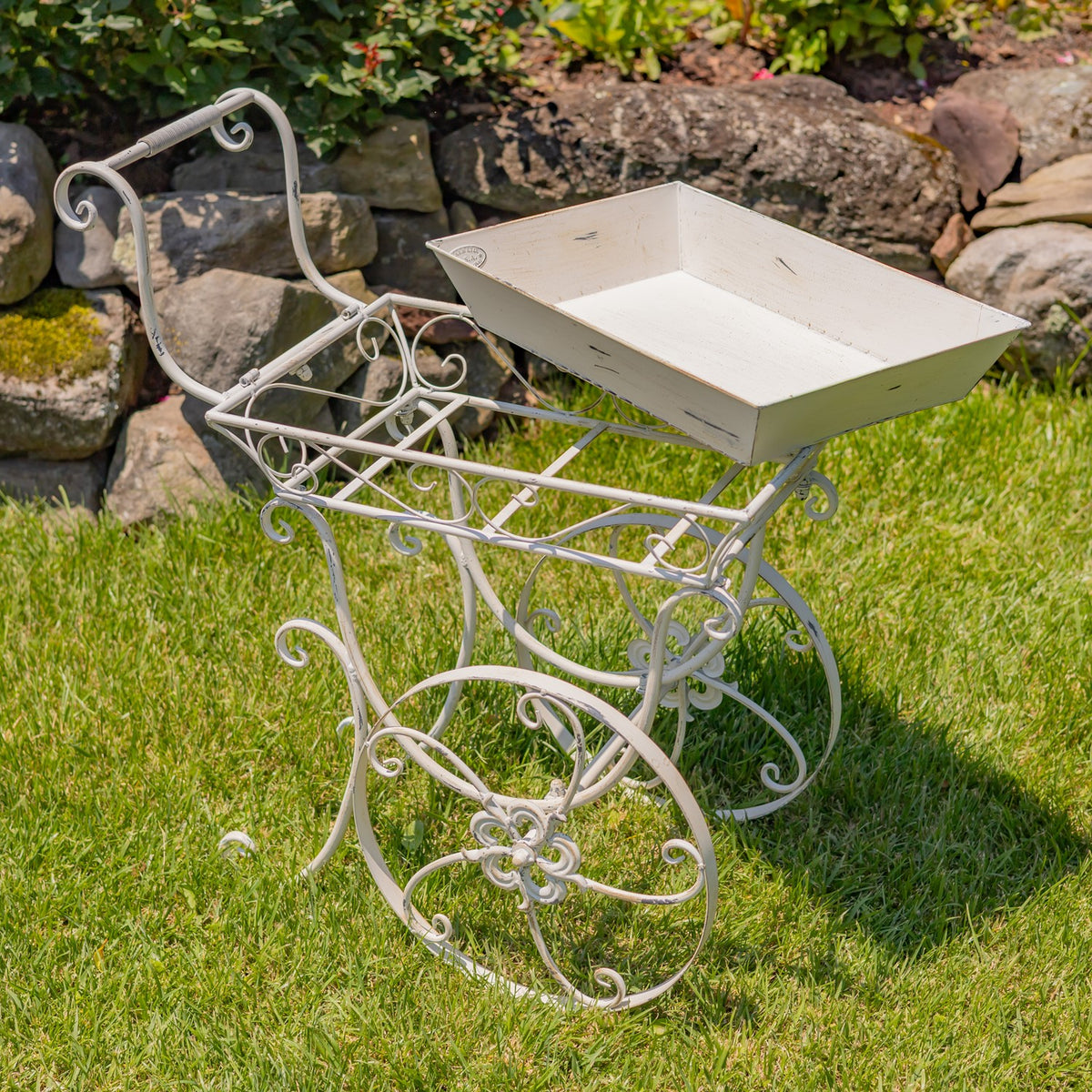 Flower cart viewed from behind, showing the open metal support frame beneath its empty tray.
