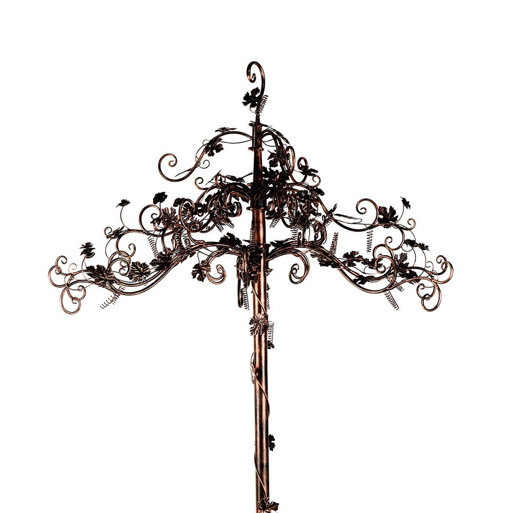 Close view of the antique bronze stand’s branching top with elaborate scrollwork and leaf accents.