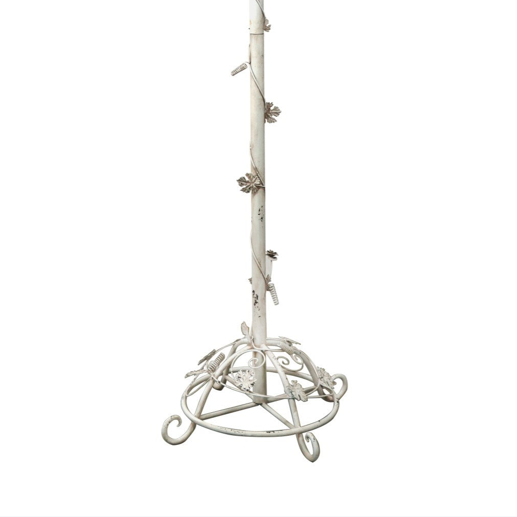 Antique white metal stem and circular base with curled feet and leaf accents.