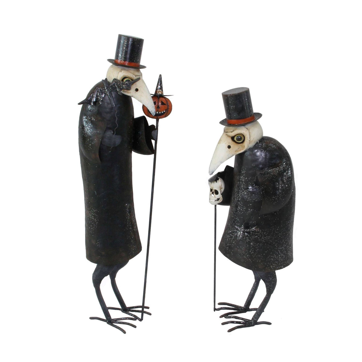 Two iron vulture figures in top hats, one holding a pumpkin cane
