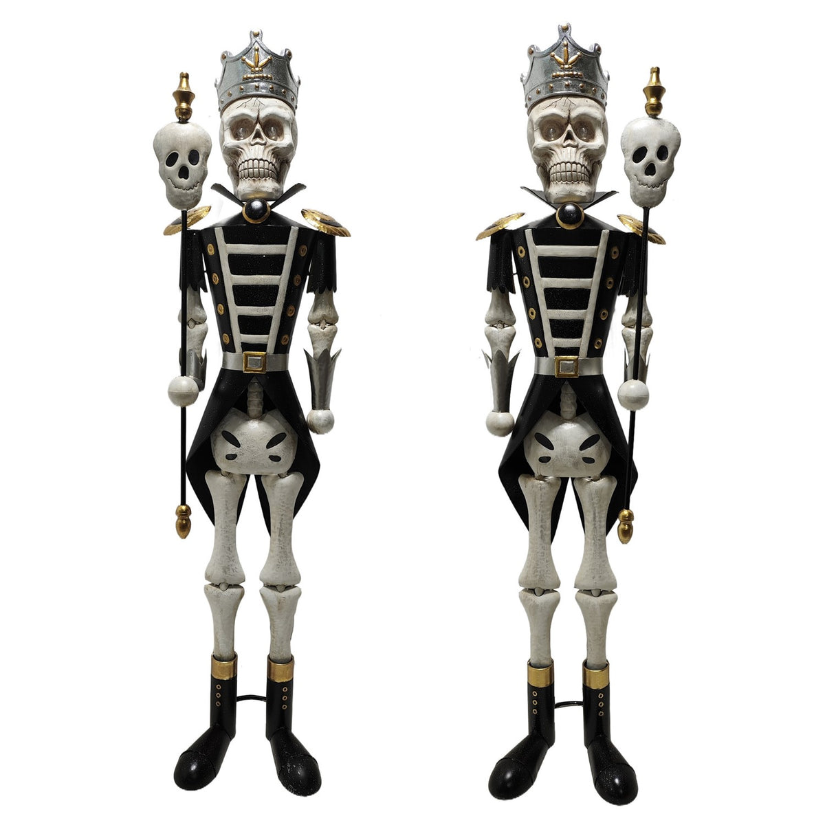 Pair of full-length black and gold skeleton sentry figures on a white background