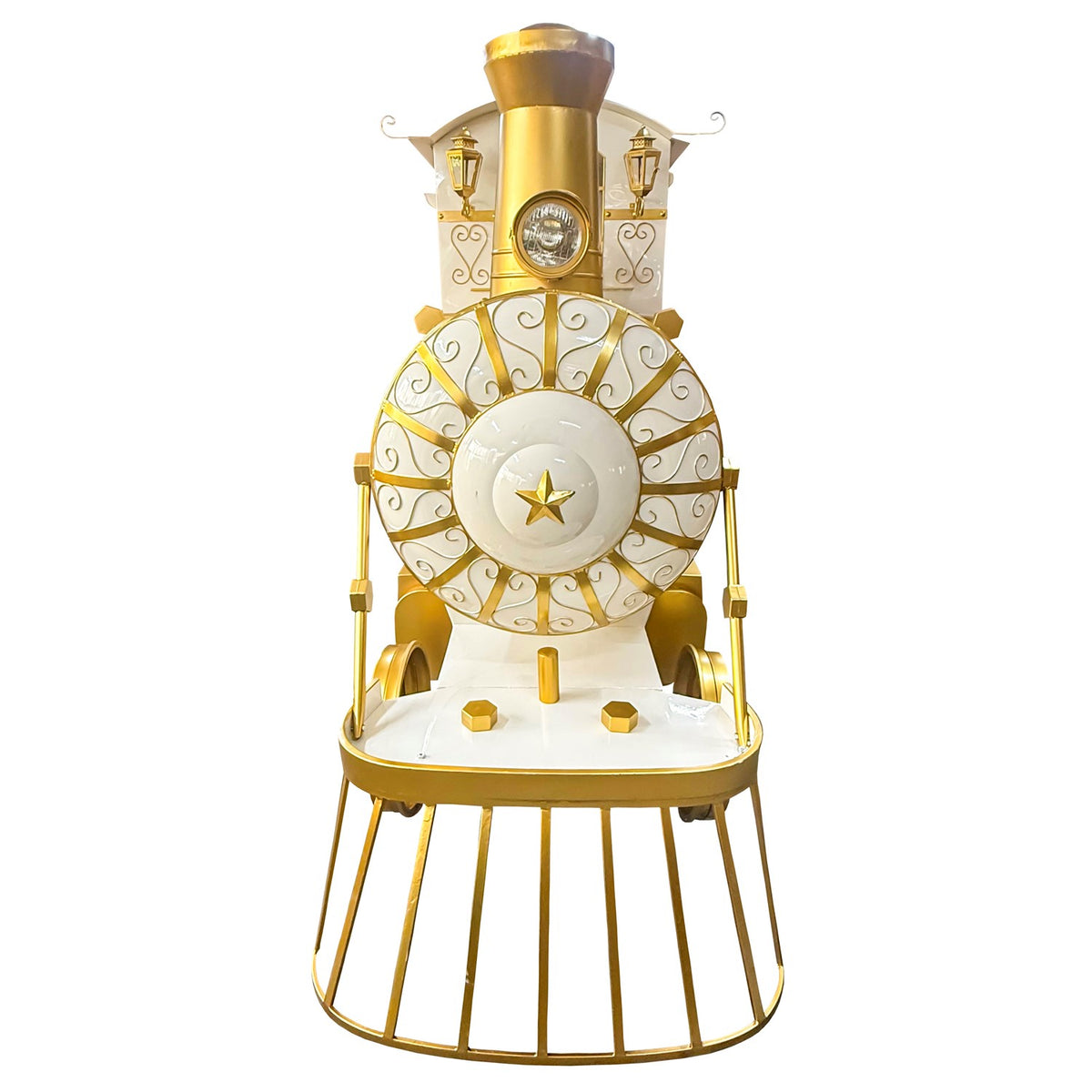 Front-facing view of the white and gold train, showing its round star-centered front and curved grille.