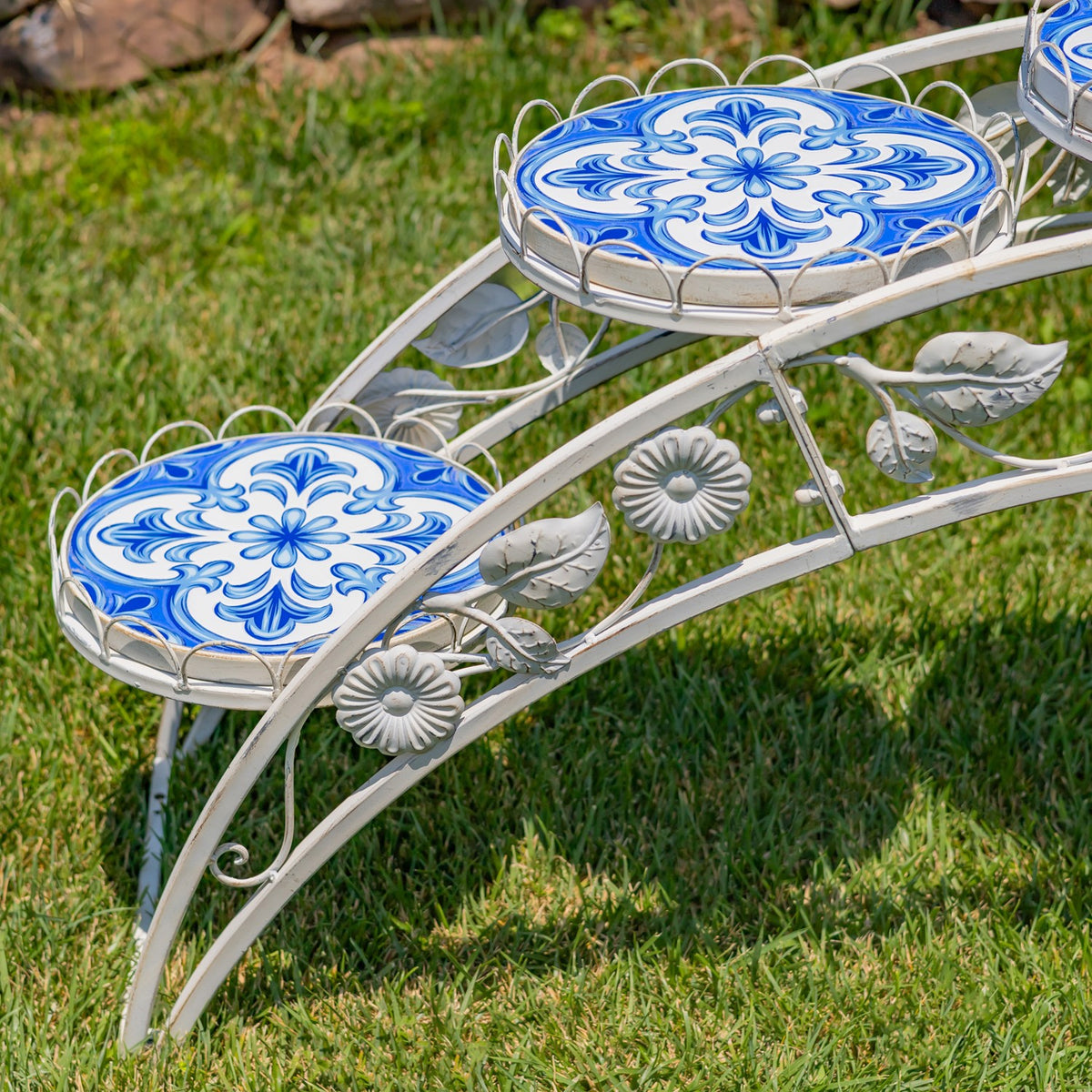 Angled close-up showing patterned mosaic platforms and decorative leaf and flower metalwork.