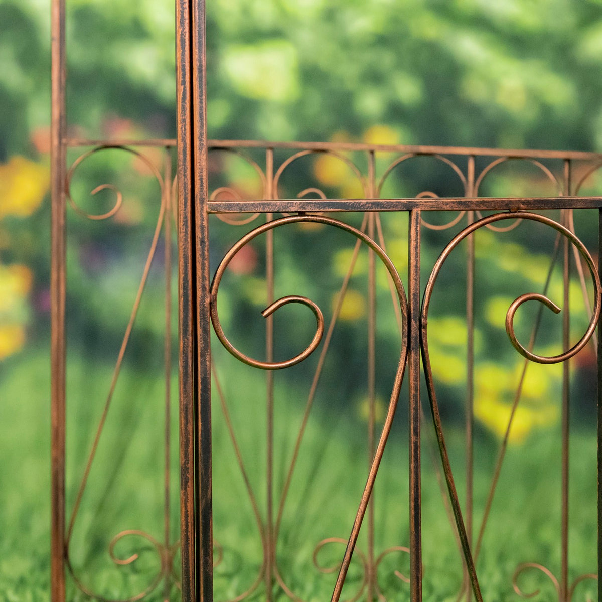 Close view of a vertical iron post and curved scrollwork in the gazebo’s side panel.