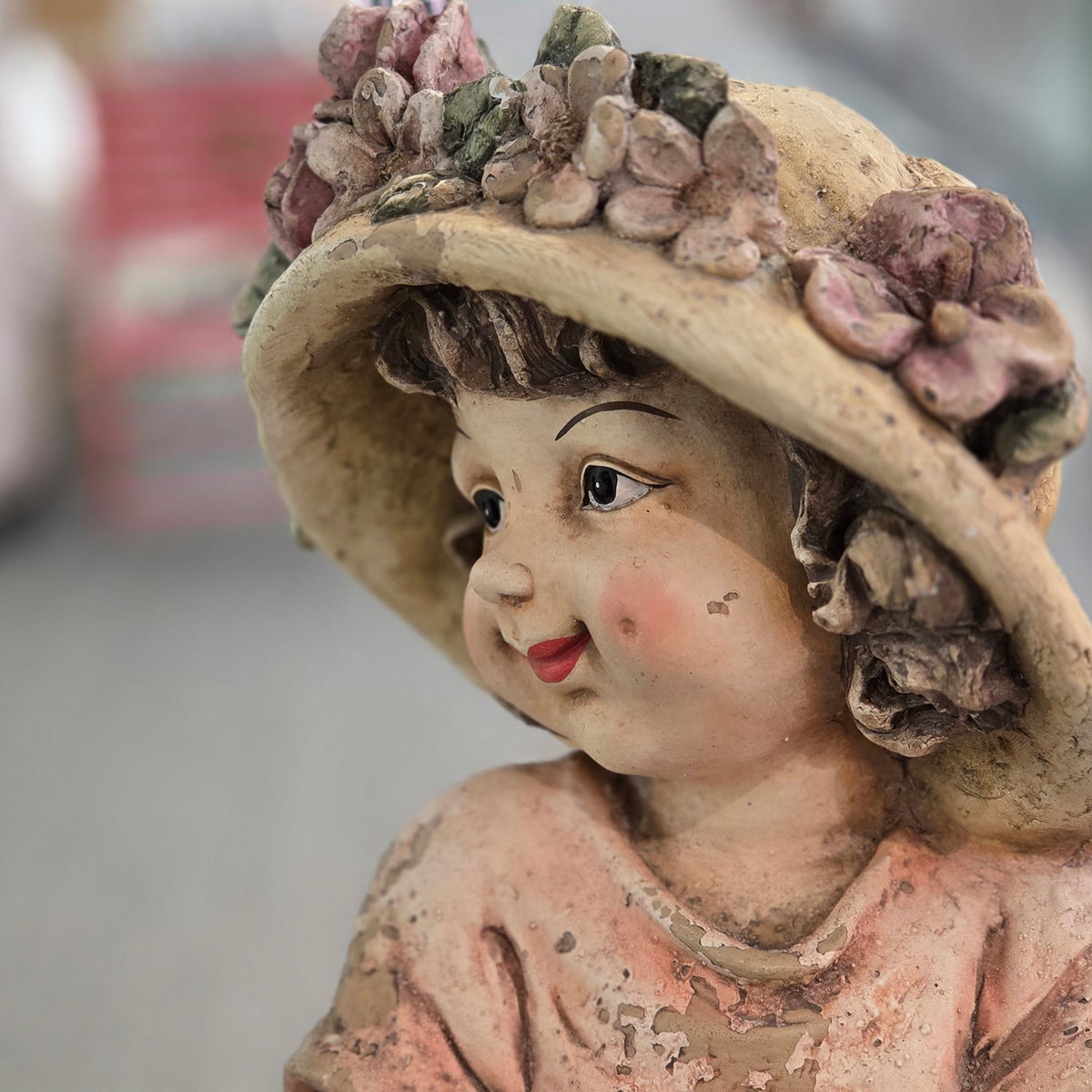 Close-up of the figurine's face and flower-decorated hat