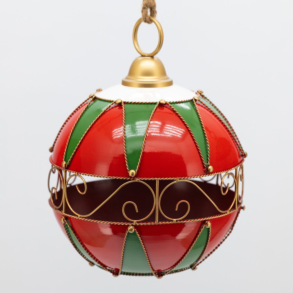 Red and green hanging ornament with a gold scrollwork band and rope hanger.