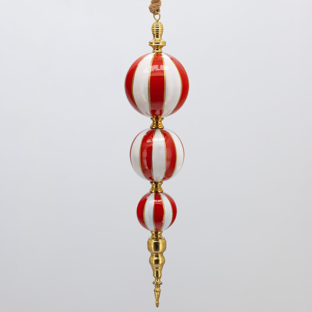 Close view of a red-and-white striped hanging ornament with three stacked rounded sections.