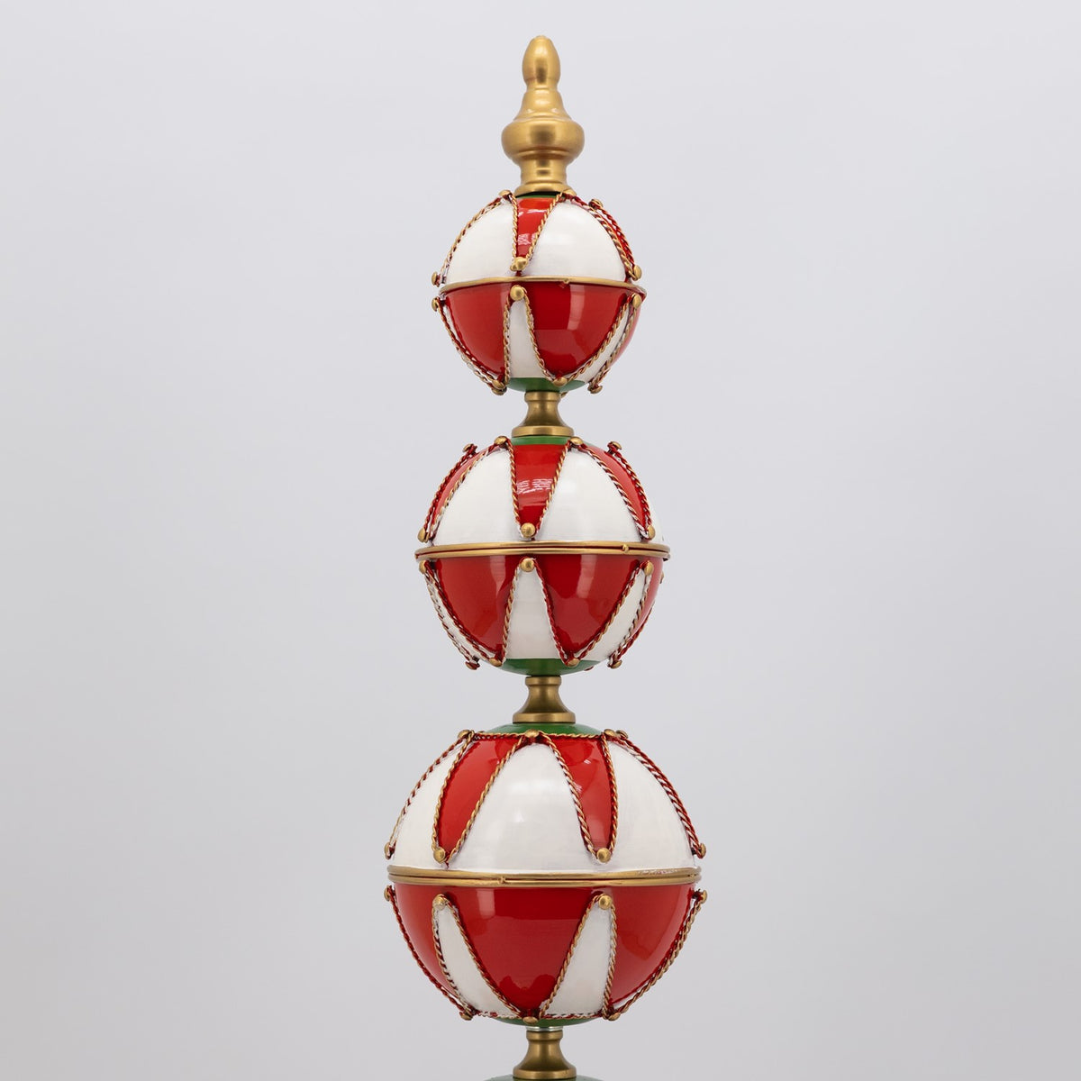 Three smaller red-and-white baubles stacked beneath a gold finial.