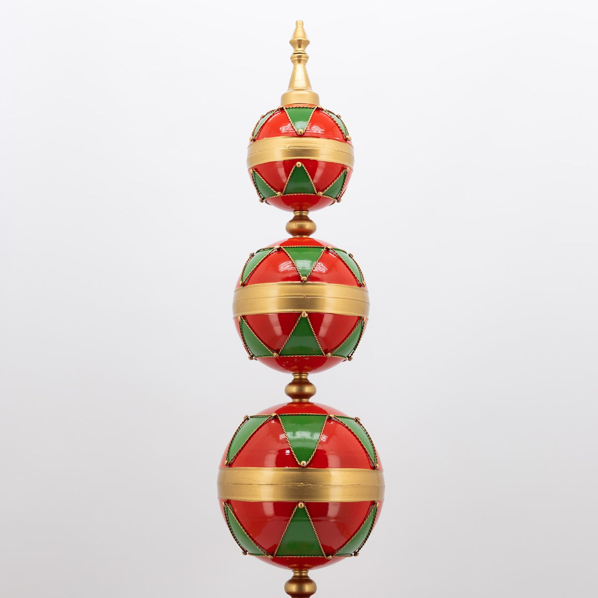 The upper three red and green patterned spheres, topped with a pointed gold finial.