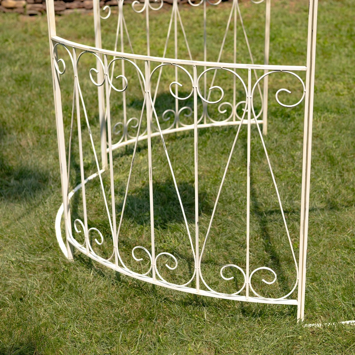 Antique white decorative iron side panel shown on grass