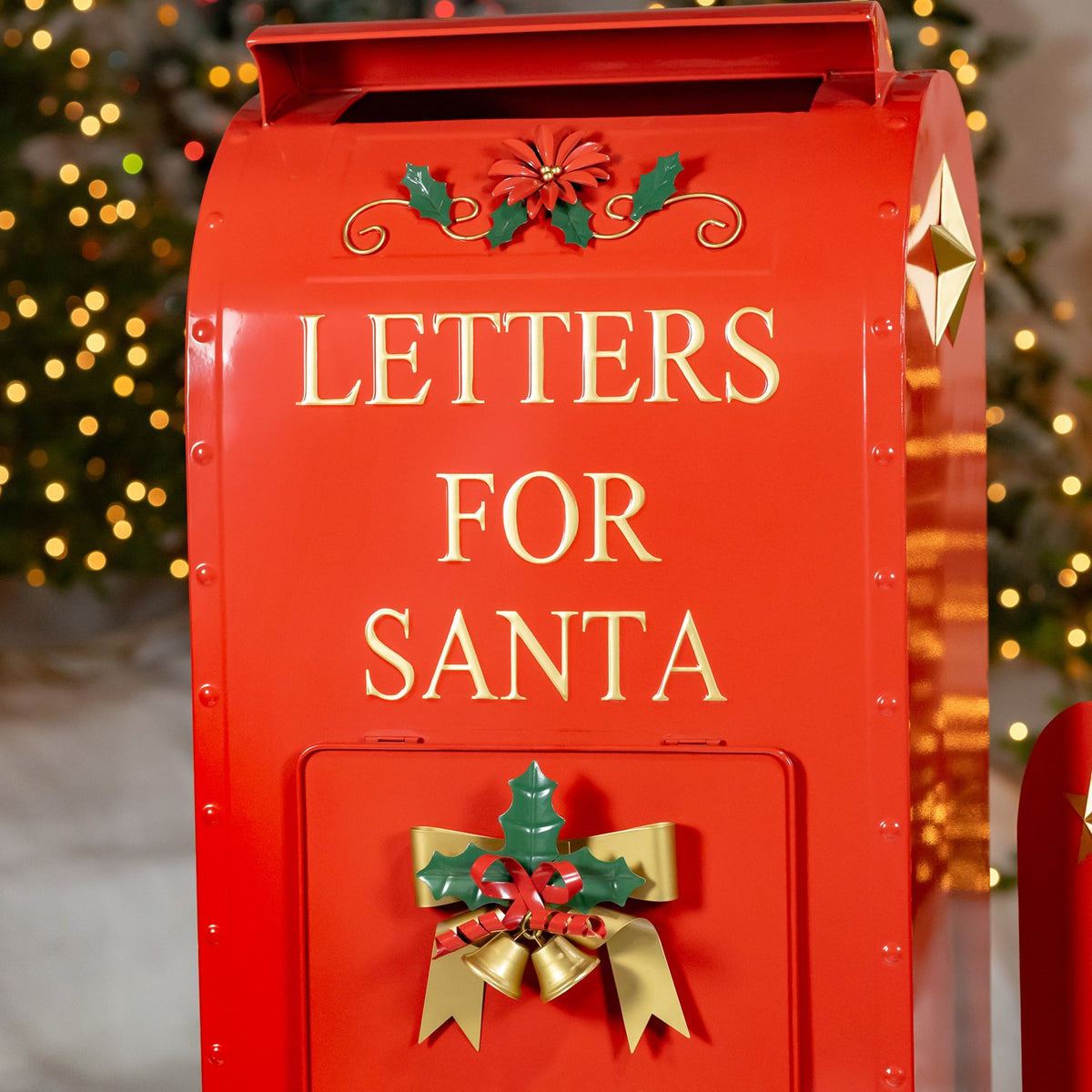 Close-up of the large red mailbox with gold lettering and holly-and-bell detail