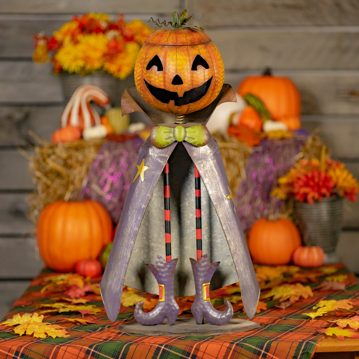 Front view of the full pumpkin figurine in a colorful autumn setting