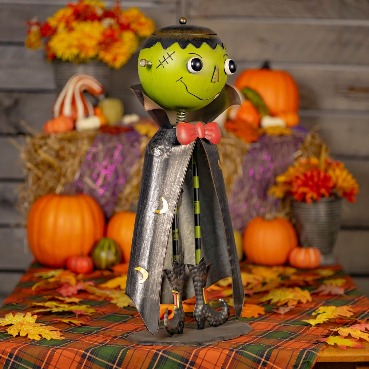 Three-quarter view of the full monster figurine in a pumpkin display