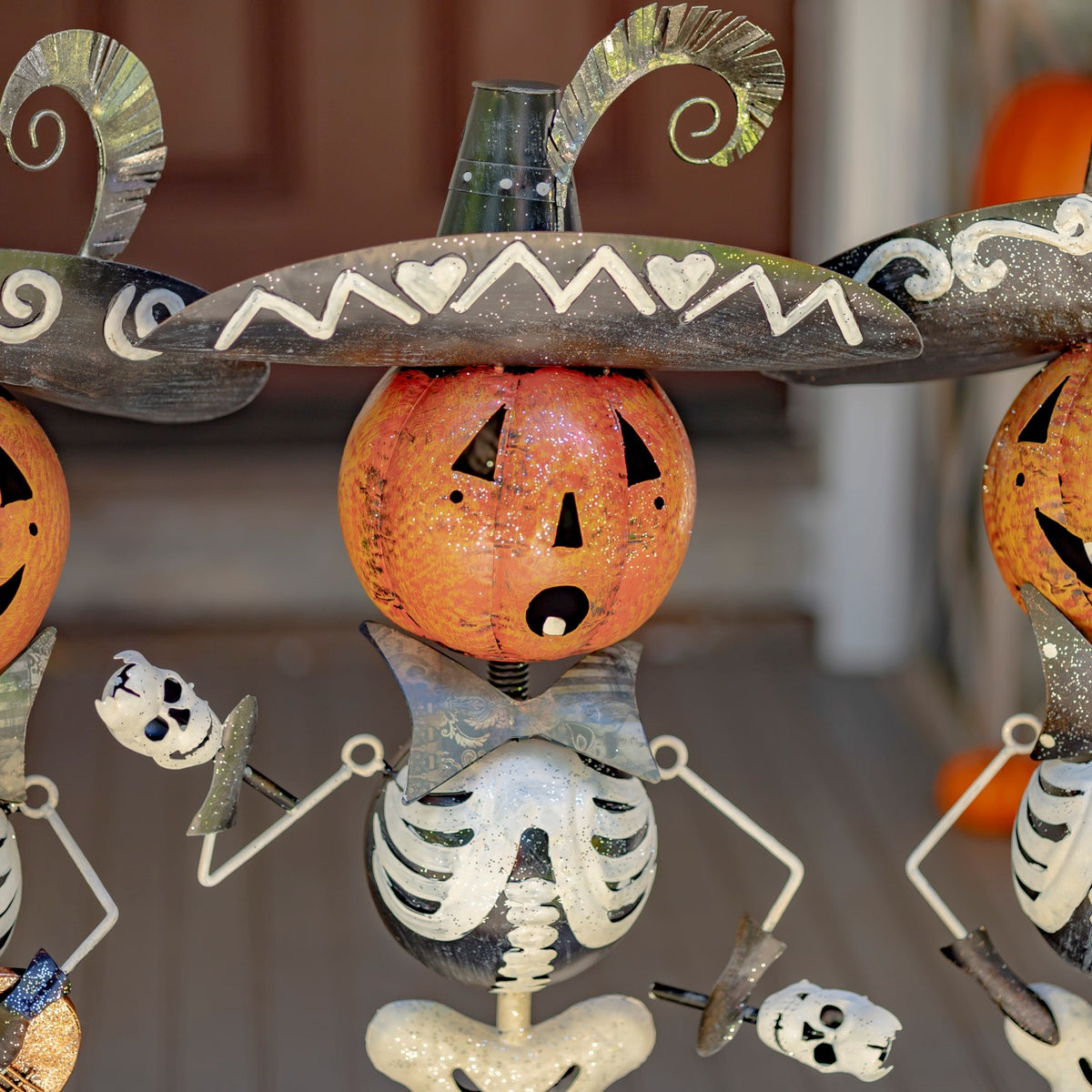 Close view of a skeleton mariachi figurine with a pumpkin head and maracas
