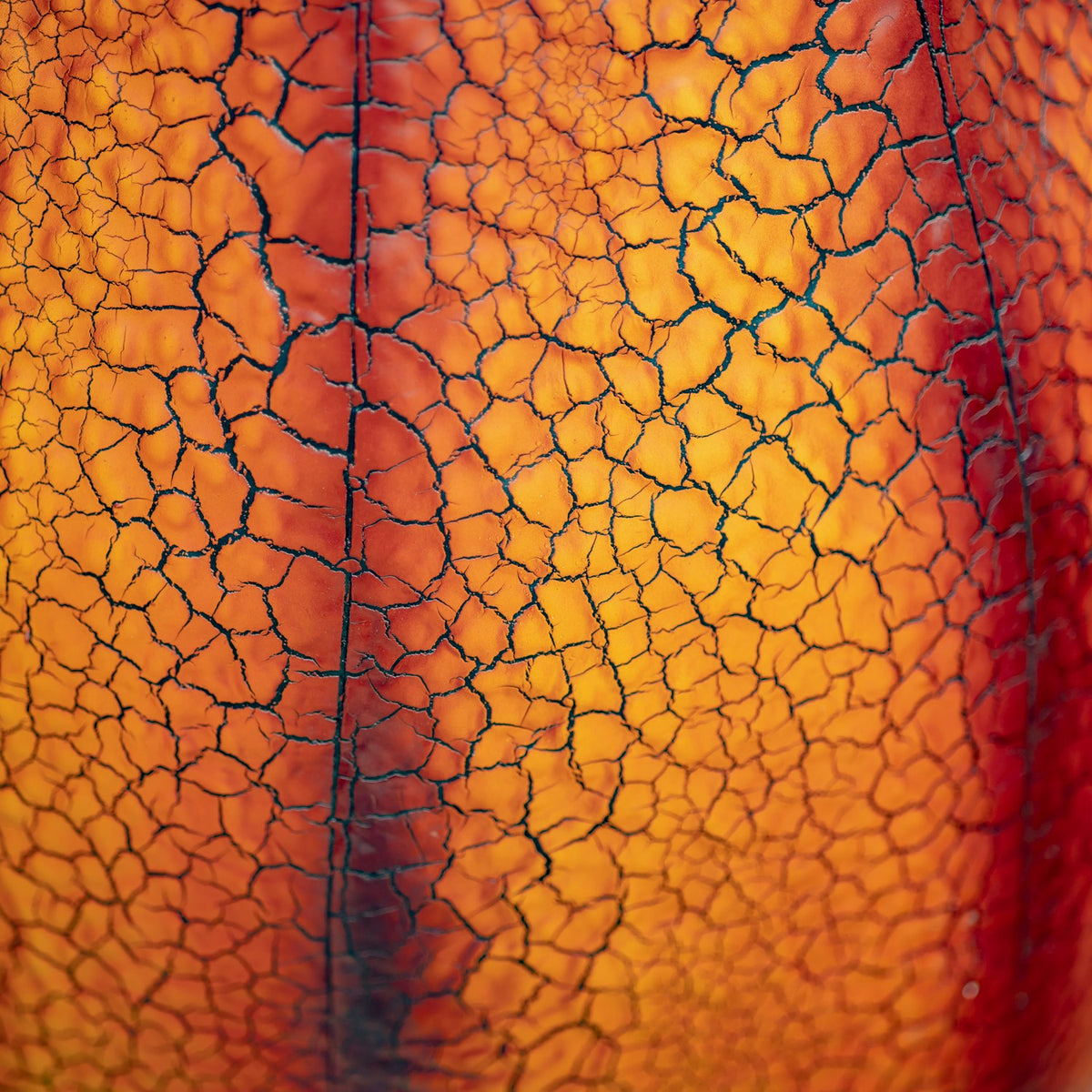 Close-up showing the orange distressed crackle finish on the metal pumpkin