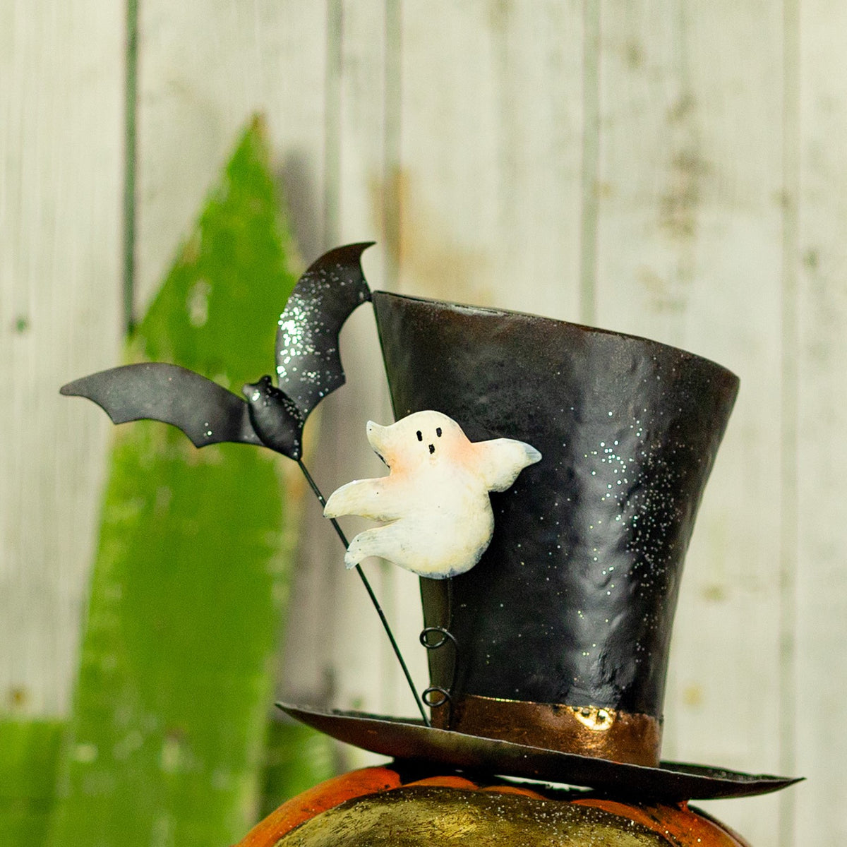 Close-up of the figurine's black top hat with a small white ghost and bat