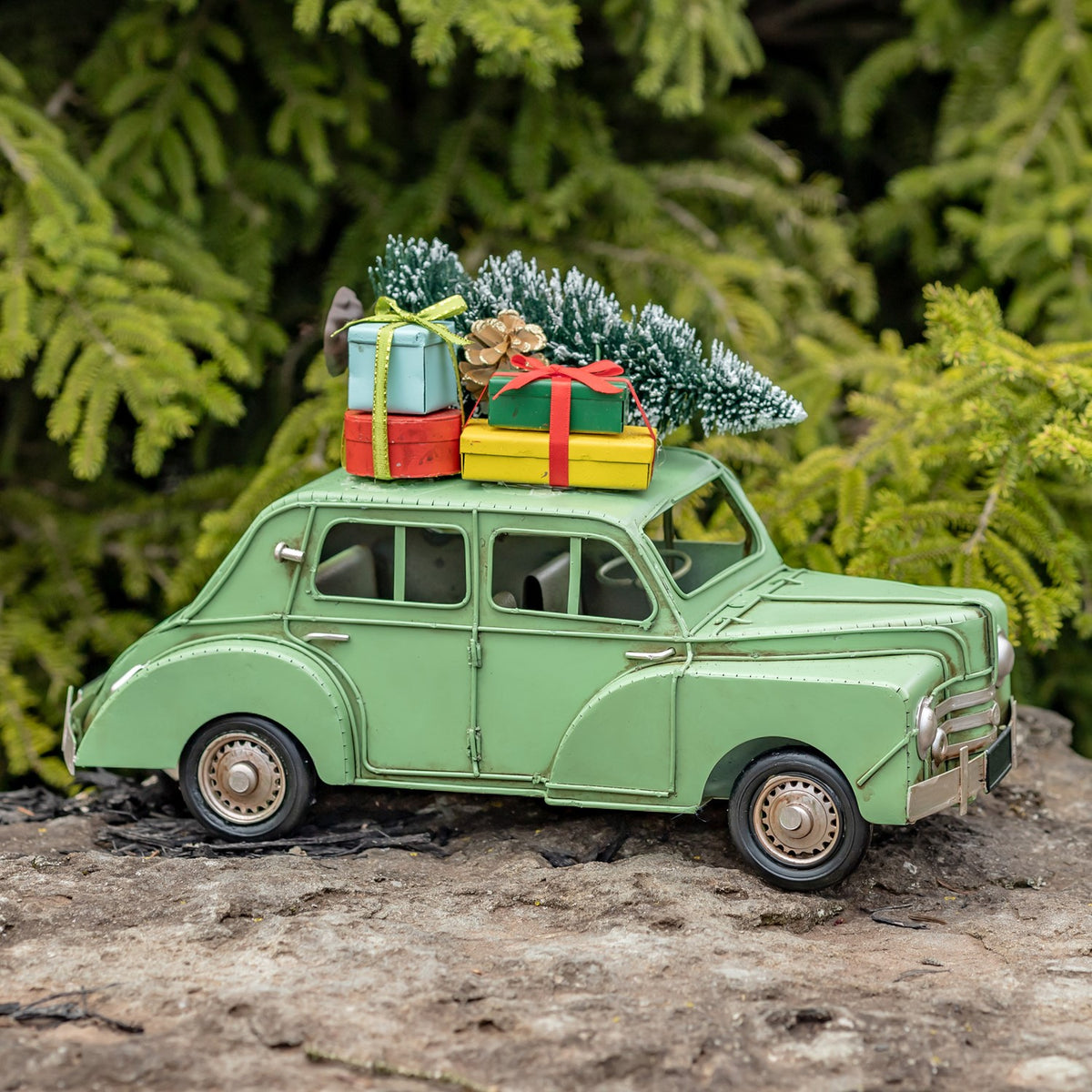 Side view of the light green vintage-style car with tree and gifts on its roof