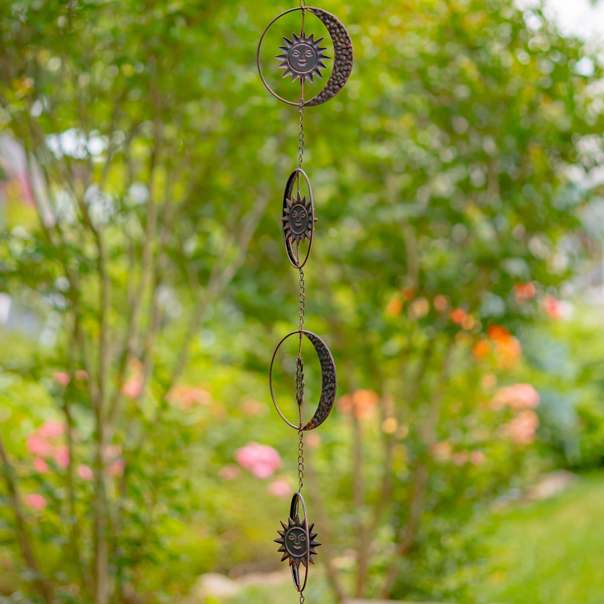 Side view of the antique bronze sun and crescent moon pieces along the chain