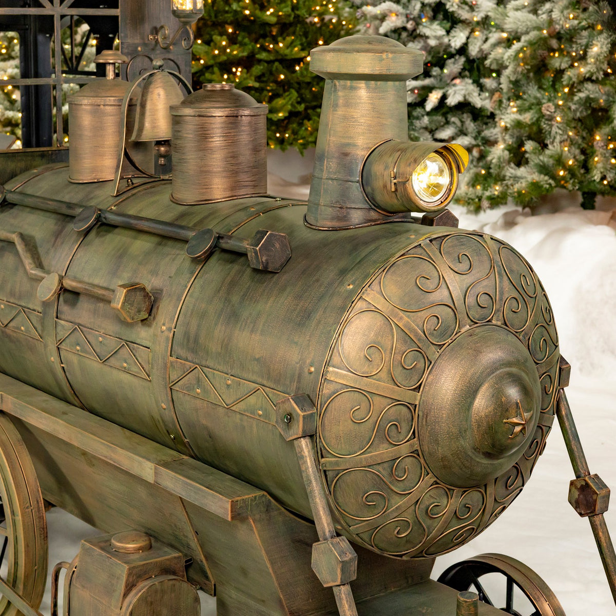 Detailed view of the train's decorated boiler, headlamp and metal fittings