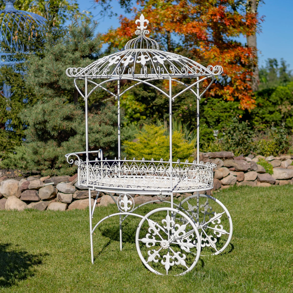White iron flower cart shown from the opposite side, with an empty basket and decorative canopy.