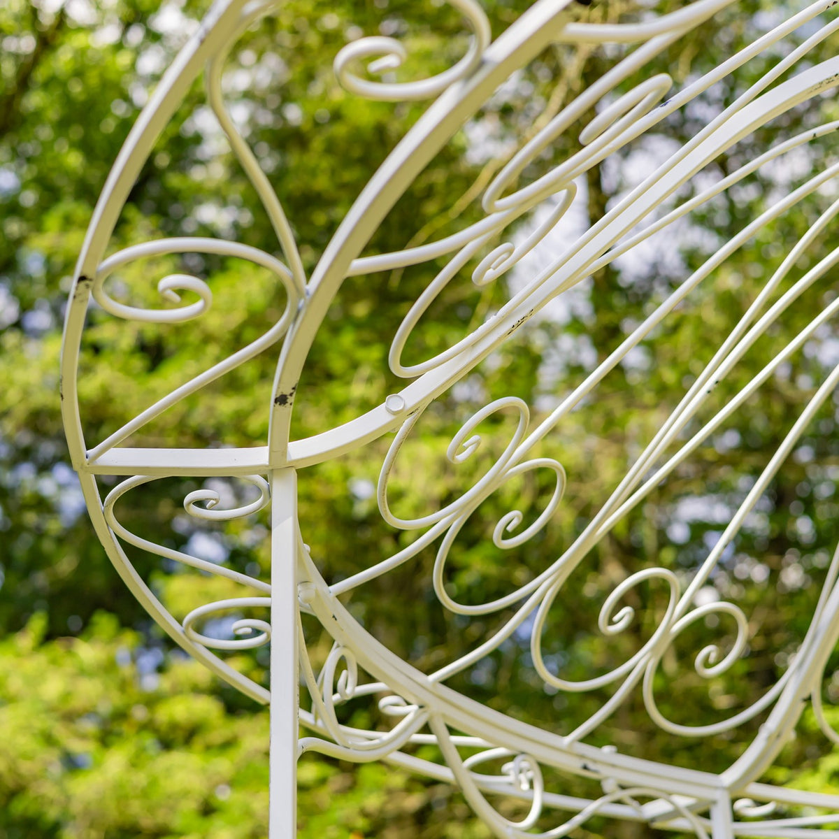 Detailed view of pale iron scrollwork on the gazebo roof