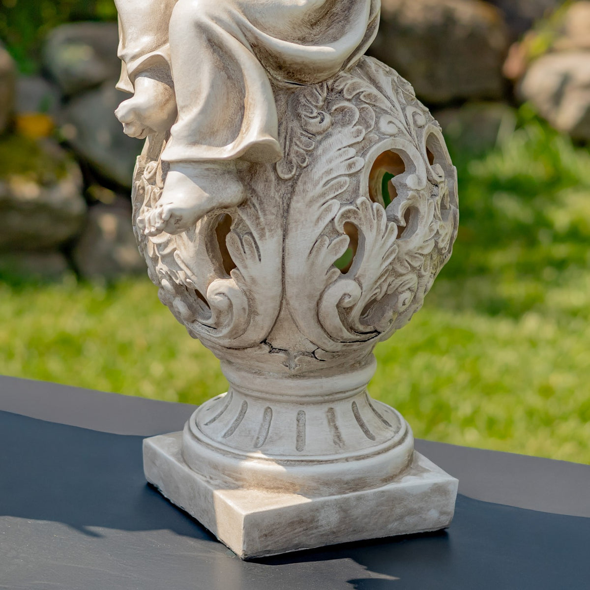 Antique grey statue base and openwork pedestal shown in close detail