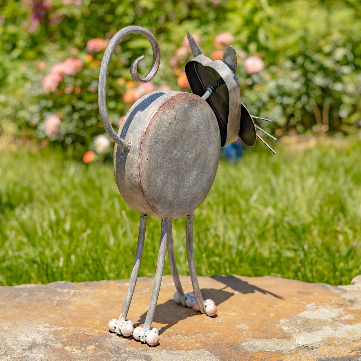 Rear three-quarter view of the cat planter with its curled tail and legs