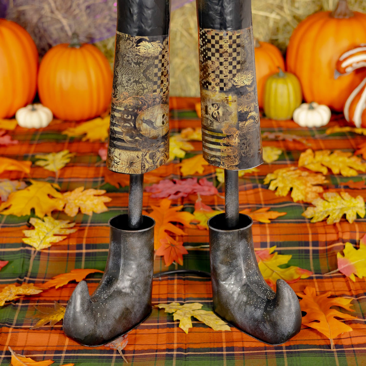 Close-up of patterned trouser cuffs and curled black boots