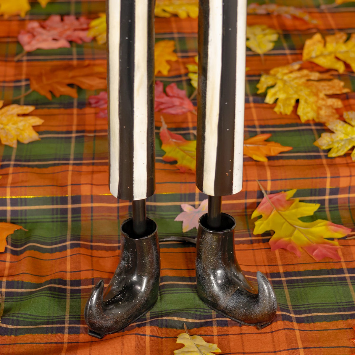 Close-up of the skeleton decoration's striped legs and black boots