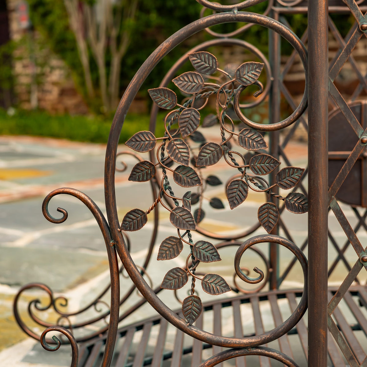 Close-up of a bronze-toned metal bridge panel with scrolling vines and raised leaf details.