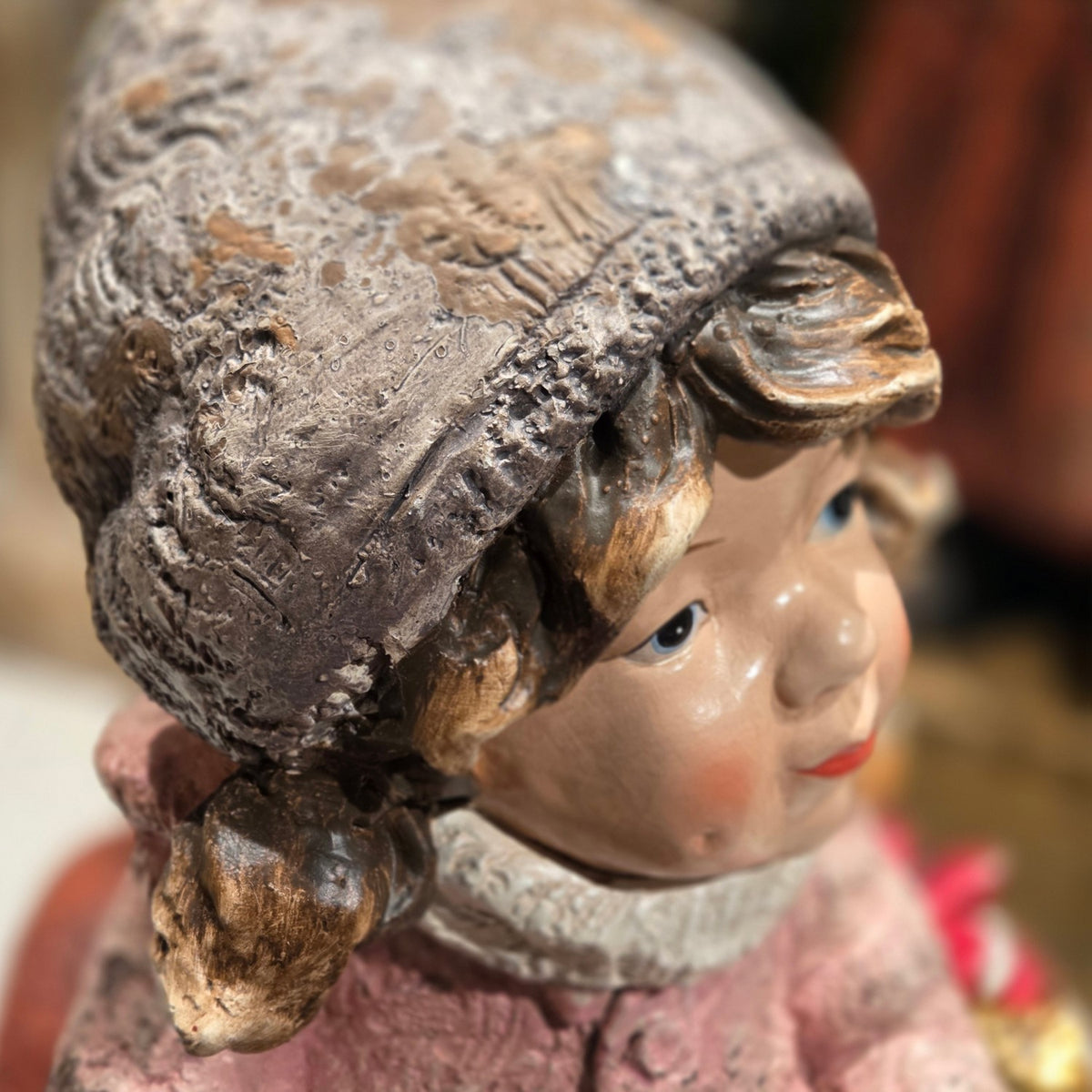 Side close-up of the girl's face and textured hat