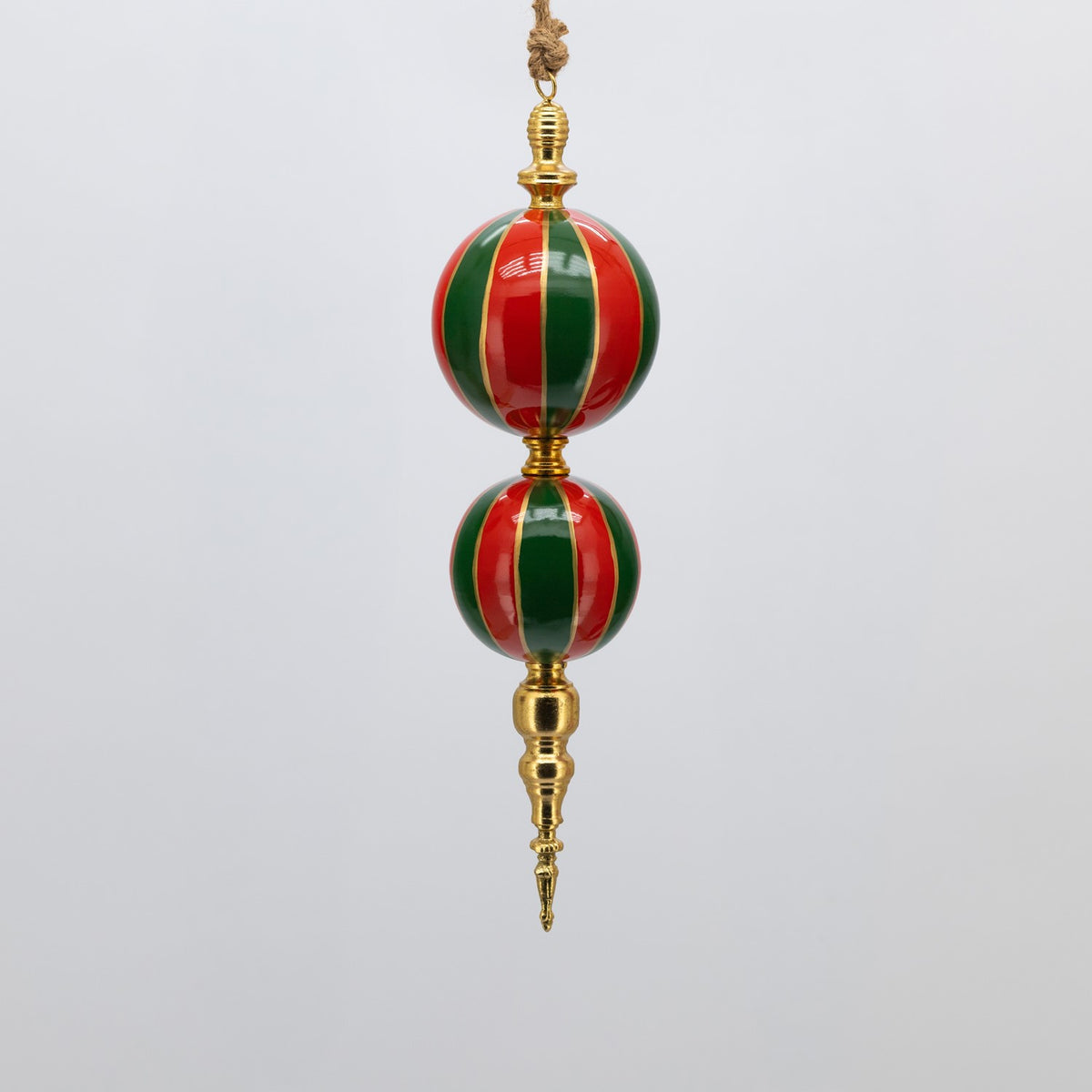 Hanging ornament with two glossy red and green striped spheres and gold-colored fittings.