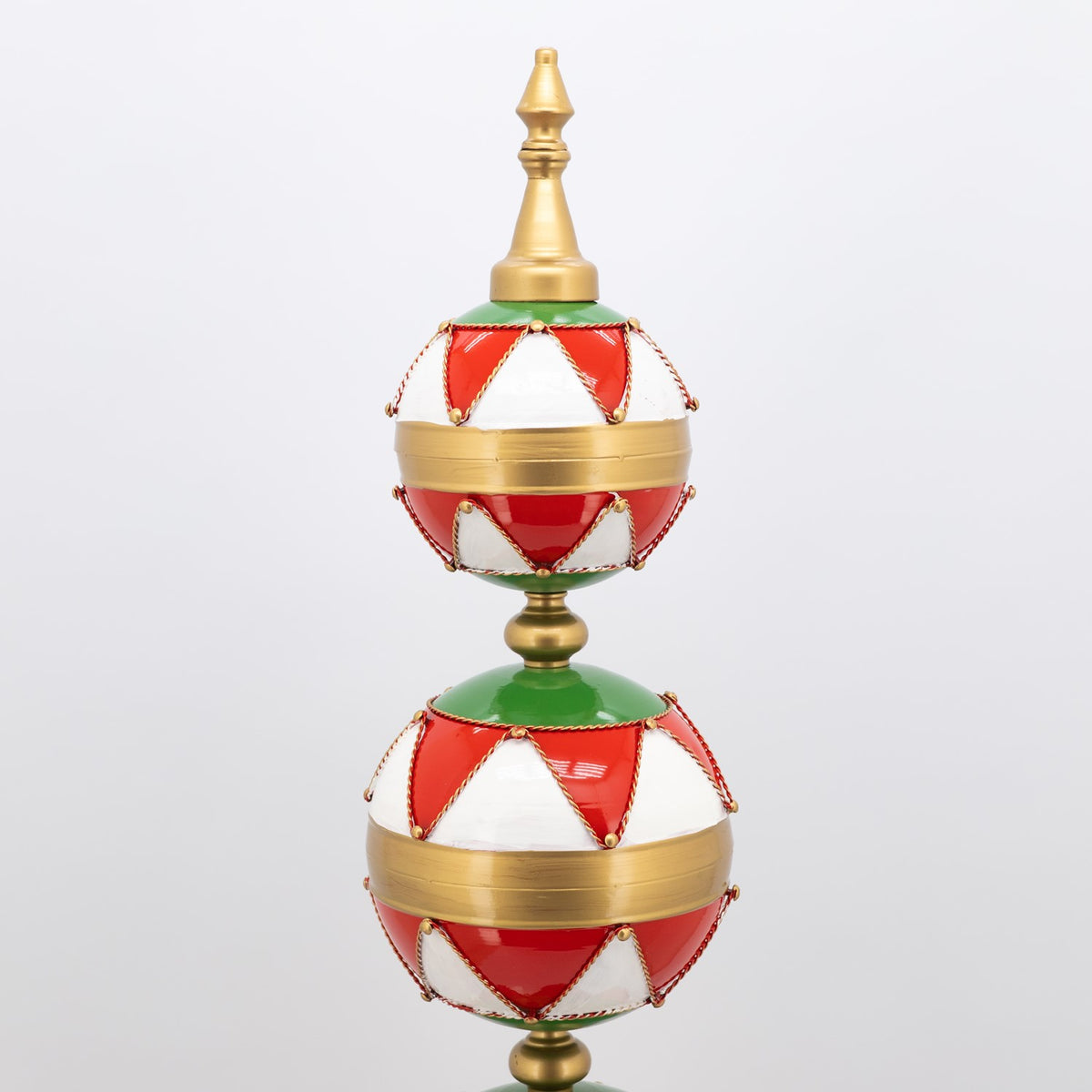 Red and white ornament tower with gold trim, showing two stacked baubles and a pointed gold finial.