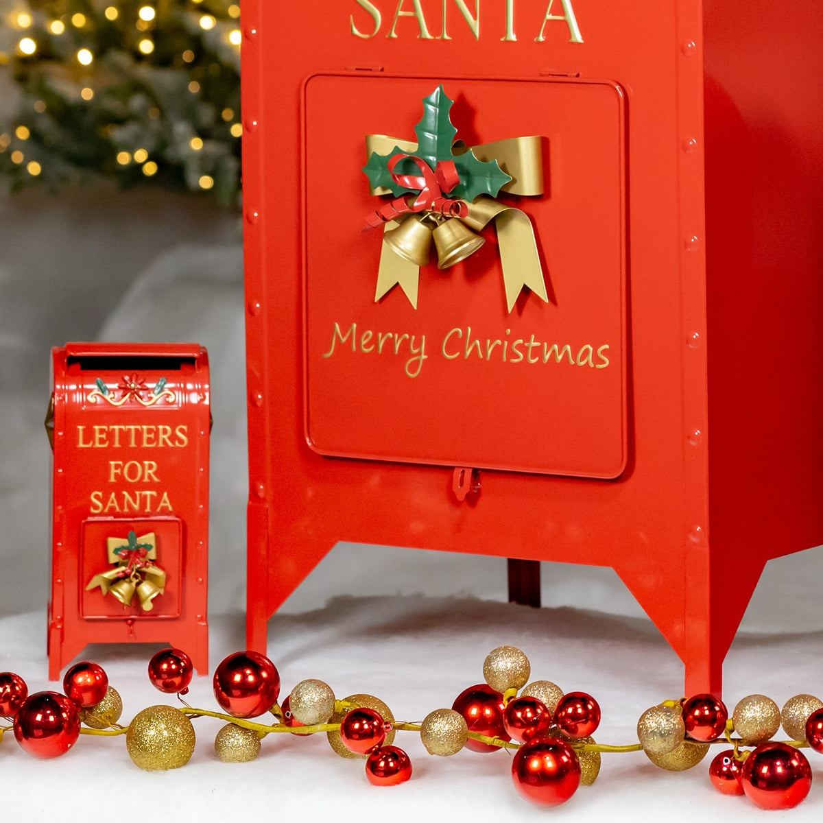 Lower front view of a large red Santa mailbox beside the smallest mailbox