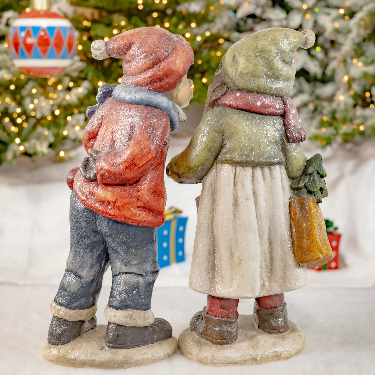 Rear view of the girl and boy Christmas figurines together