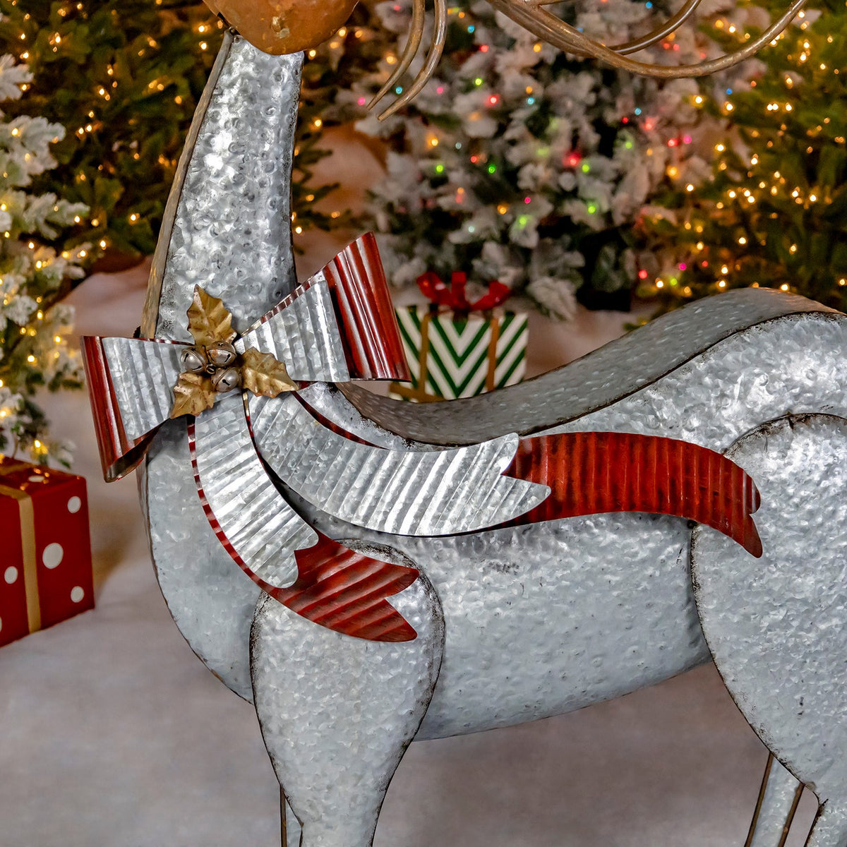 Close view of the reindeer's corrugated red-and-silver bow and galvanized metal body.