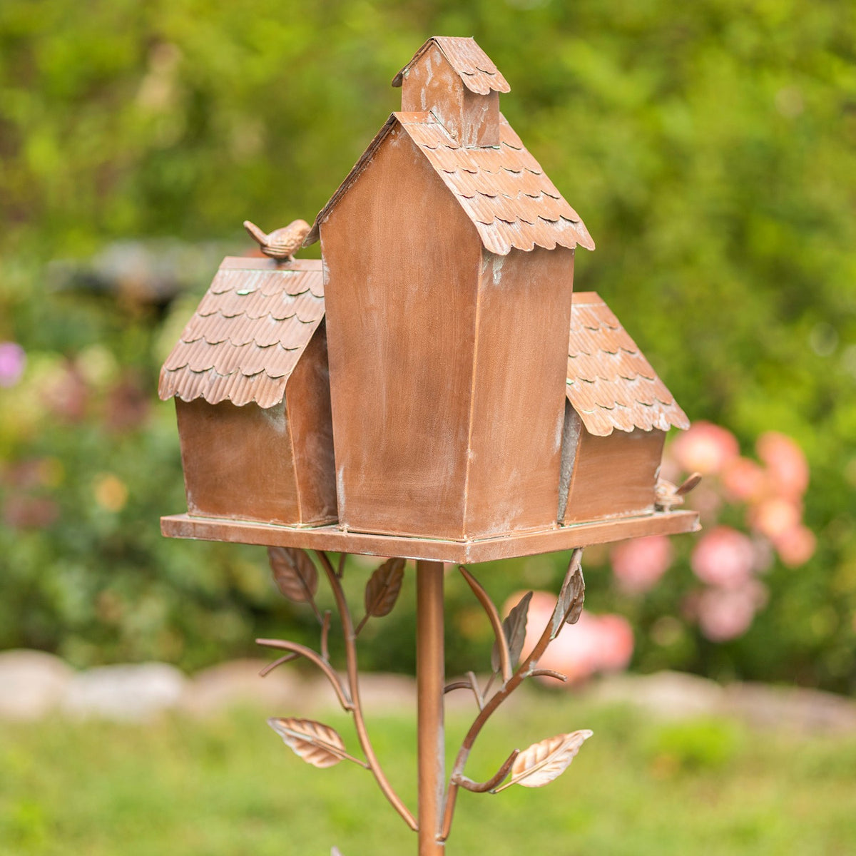 Rear view of the birdhouse cluster with plain backs and the leafy metal stake