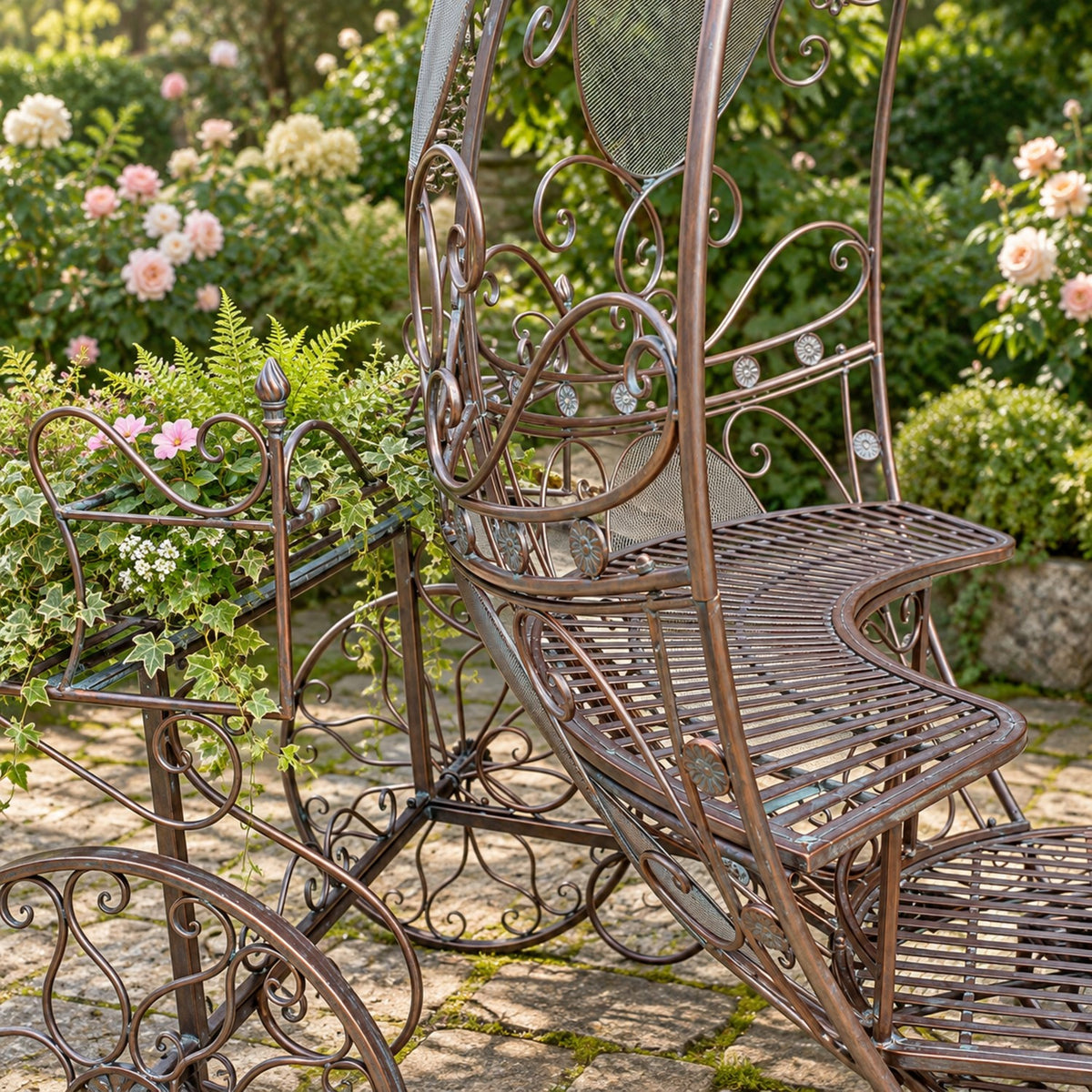 Angled detail of the iron carriage seat, decorative frame and flower planter