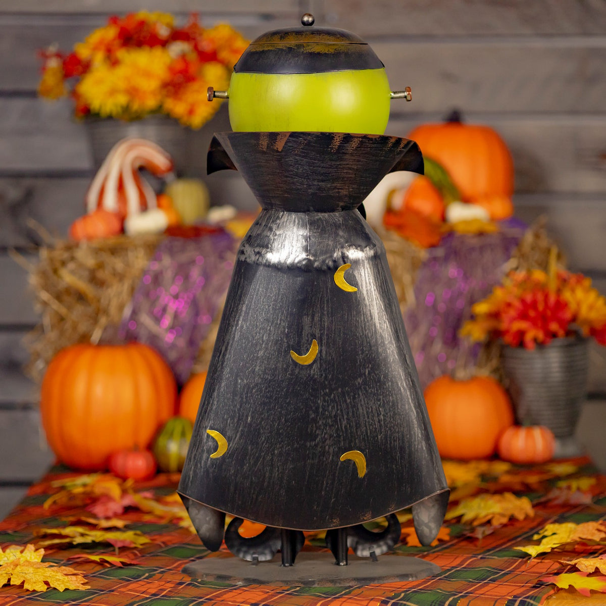Rear view of the monster figurine showing its dark cape and green head